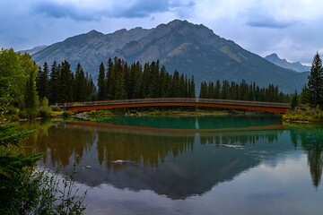 Moody Mountain Reflections On The Banff Bow River