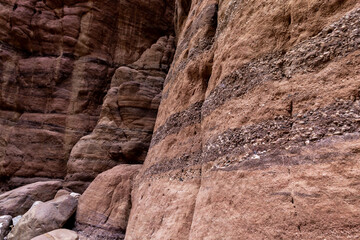 Bizarre  natural stripes on rock walls along a shallow stream along the Wadi Numeira hiking trail in Jordan
