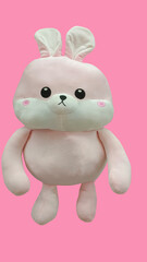 Rabbit toy isolated at pink background. Stuffed puppet animal.