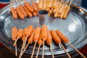 Skewers of streetfood on a table in Thailand,Steamed hot dogs