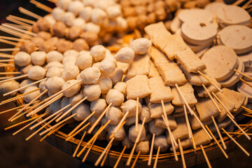 Skewers of streetfood on a table in Thailand,Steamed hot dogs