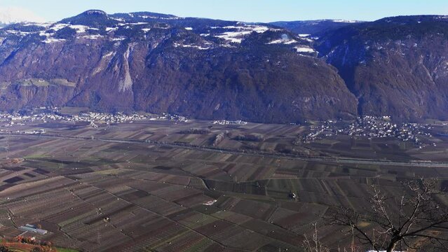View over orchards in winter in the Adige Valley towards the Tsch&ouml;gglberg mountain, Burgstall and Gargazon, South Tyrol, Italy