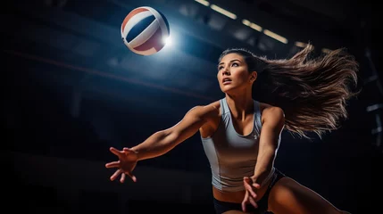 Fotobehang Female volleyball player is jump serving the ball from the backcourt. copy space for text. © Naknakhone