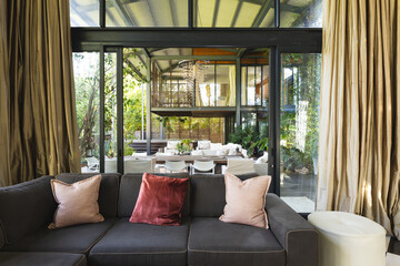 Modern big empty house with balcony and many chairs with big green garden