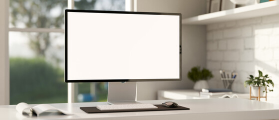 Minimalist white workspace with a white-screen computer mockup on a white desk.