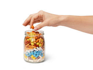 a hand taking a pill from a jar full of pills