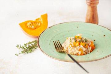 Pumpkin risotto with fresh thyme in plate. Italian Food