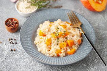 Pumpkin risotto with fresh thyme in plate. Italian Food