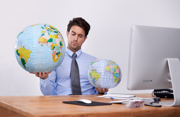 Travel, choice or confused businessman with planet, earth or worldwide destination for trip in office. Computer, holiday or professional agent with map of globe for geography or international journey