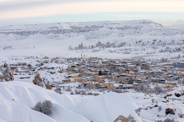 Pigeon Valley and Cave town in Göreme in winter, Fairy chimneys, Cappadocia, Turkey.