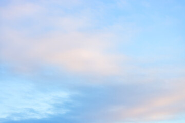 Fototapeta premium A beautiful sky tinted by the sun leaving vibrant shades of gold, pink, blue and multicolored. Clouds in the twilight evening and morning sky. Cloudy sky background in the evening and during the day.