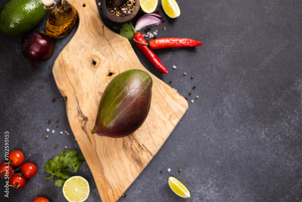 Wall mural Tropical mango fruit on a wooden cutting board