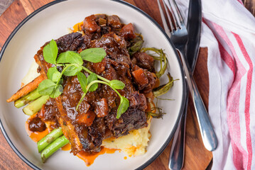 Red wine braised short ribs with grilled carrot and green vegetables