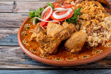 Rice congri with pork fricassee, salad and fried ripe plantain. Typical Cuban food.