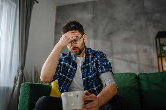 one adult caucasian man measure check blood pressure at home