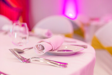 Wedding reception restaurant interiors, tables, plates, glasses and cutlery