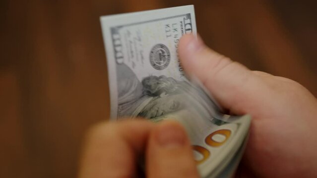 Male hands counting money close-up.