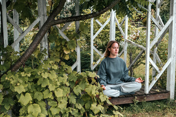 meditation Woman meditates in nature outdoor.At ground level, a relaxed woman meditates and...