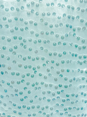 Glass drops on fabric as an abstract background. Texture