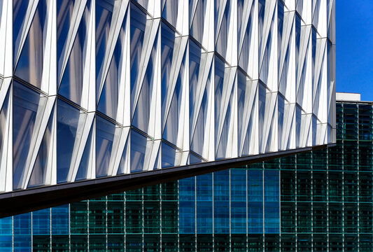 Geneva, Switzerland, Europe - self-shading glass facade - headquarters of Japan International Tobacco, JIT, in background green glass facade of WMO - World Meteorological Organization, UN