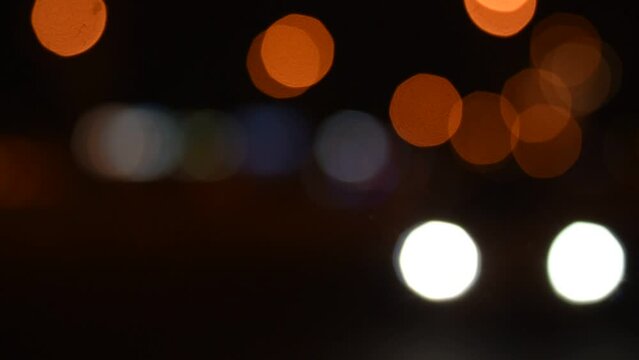 Beautiful bokeh on night background with blurry lights. Night lights in city, haze, depth of field, round bokeh, circle bokeh
