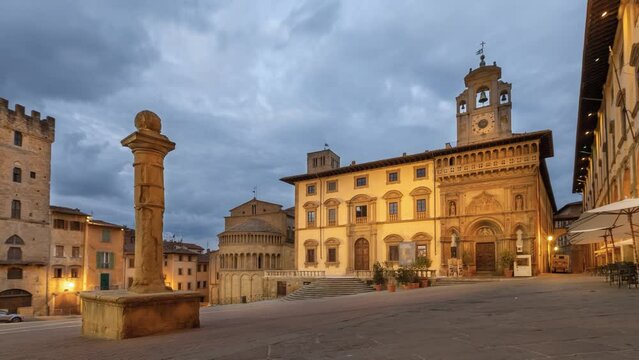 Arezzo, Italy. Time lapse view of  historic architecture on Piazza Grande square at dusk
