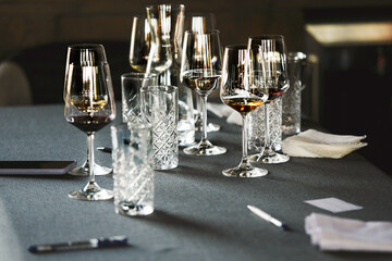 Various alcoholic beverages in glasses in white table in wine room. Sommelier school, professional...