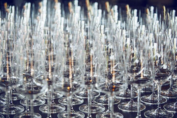 Lots of empty wine glasses on the bar, close up. Restaurant serving. 