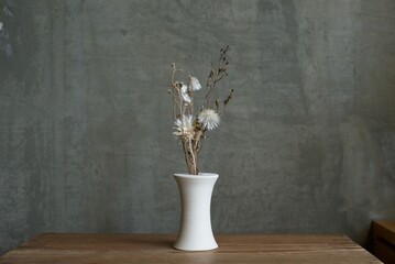 Fototapeta na wymiar 陶器の花瓶に入れたドライフラワー