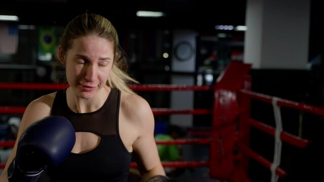 Girl in boxing gloves at Muay Thai training.
