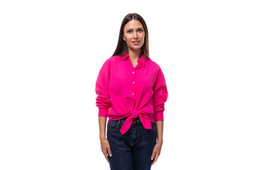 young slim brunette leader woman wears a bright pink shirt on a white background