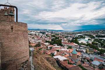 View of Tbilisi Old town from Narikala fortress with the Koura river, the bridge of peace,  the...