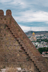 View on the bricks walls of the medieval Narikala fortress and the recent Sameba cathedral with its...