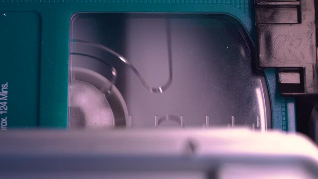 Macro Close Up of Video Cassette Tape Starts Playing in VHS Player and Recorder