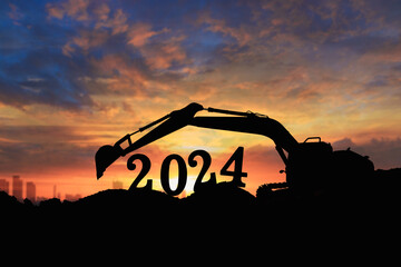 Fototapeta na wymiar Concept happy new year 2024,crawler excavator silhouette with lift up bucket .On sunrise backgrounds