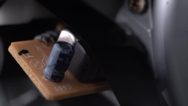 Video Cassette Tape Moving on Mechanism and Electronic Components of VHS Player, Macro Close Up