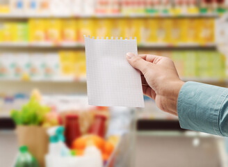 Woman holding a blank shopping list