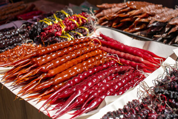 A lot of red churchkhela is on the table for sale