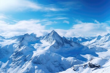 Fototapeta na wymiar Snow-covered peaks under a clear blue sky in a mountain range