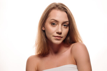 Beauty portrait of pretty blonde girl on isolated white background. Skin care concept