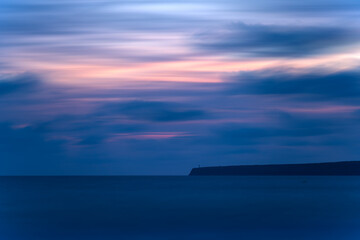 "Dusk photo of Cape Barberia, Formentera featuring silhouetted lighthouse."