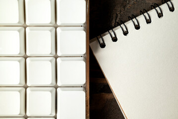 Closeup view of a computer keyboard with an empty notebook