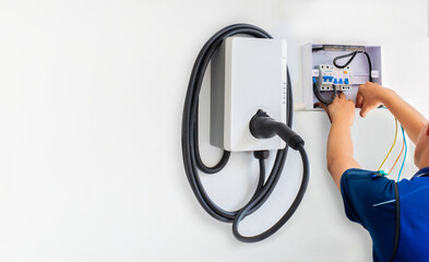 Certified male Electrician Installing Home EV Charger