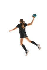 Dynamic portrait of focused female handball athlete in mid-throw, showcasing athleticism and dedication against white background. Concept of professional sport, movement, dynamic, championship. Ad
