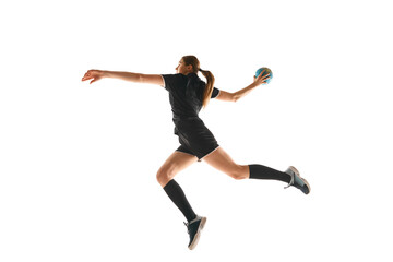 Fototapeta na wymiar Talented handball player, female sportsman practicing techniques, capturing intensity of sport against white studio background. Concept of hobby, movement, dynamic, active lifestyle, championship.