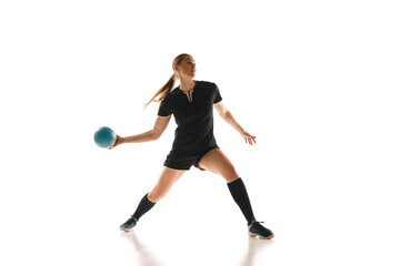 Concentrated female handball player perfecting her throw, highlighting strength and precision against white studio background. Concept of professional sport, movement, dynamic, workout, championship.