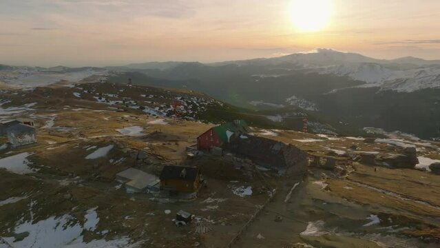aerial view over wooden retreat cabin cabana babele in bucegi mountains in romania during sunset