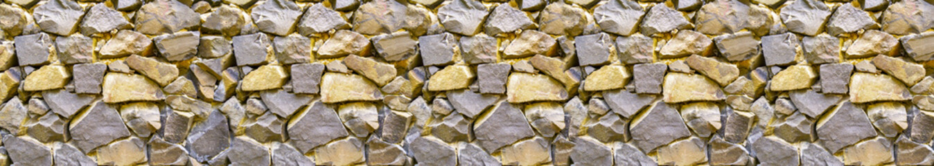 Close-up image of the wall. Rough, natural stone texture. Stone of different sizes and shapes. Template for interior design, websites or promotional materials. Banner for insertion into site.