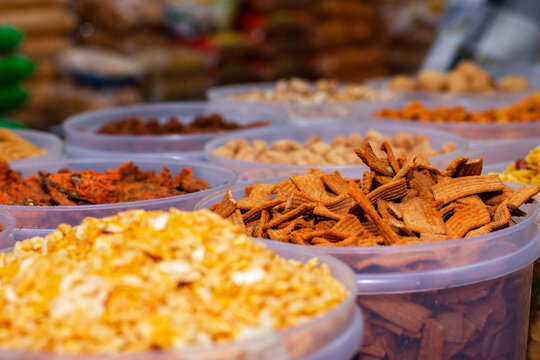 A seller selling delicious Gujarati salty snacks items at Industrial trade fair in Kolkata, West Bengal, India.