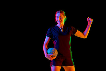 Young woman, professional handball athlete happy because she scored perfect decisive goal against...